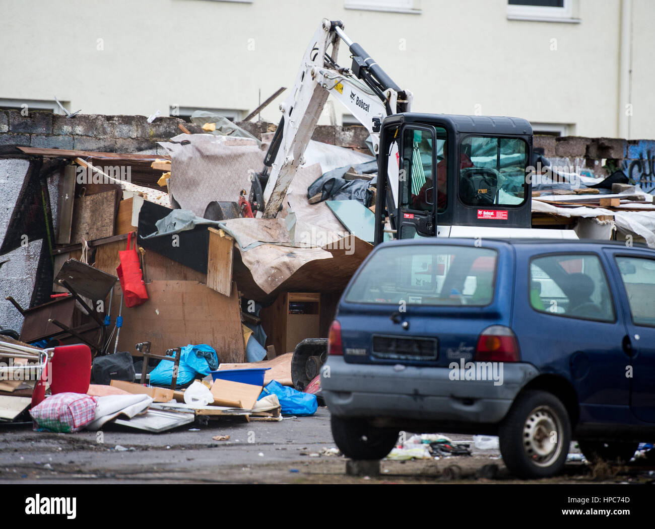 The handbuilt huts of the property's residents are torn down on a commercial property in the Gutleutviertel district on the outskirts of Frankfurt am Main, Germany, 21 February 2017. Several dozen Romanians were living in the wooden sheds. Photo: Susann Prautsch/dpa Stock Photo