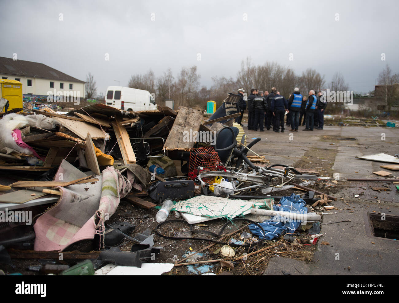 State police officers stand before the ruins of the handbuilt huts on a commercial property in the Gutleutviertel district on the outskirts of Frankfurt am Main, Germany, 21 February 2017. Several dozen Romanians were living in the wooden sheds. Photo: Susann Prautsch/dpa Stock Photo