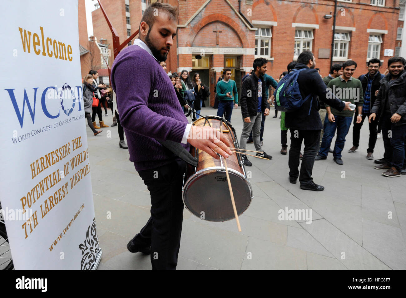 London, UK. 21st Feb, 2017. A man plays a drum for Pakistani students at the London School of Economics (LSE), taking part in a Bhangra flash mob around the campus before boarding a brighly decorated 'Bhangra bus' for a parade around the local area. Credit: Stephen Chung/Alamy Live News Stock Photo