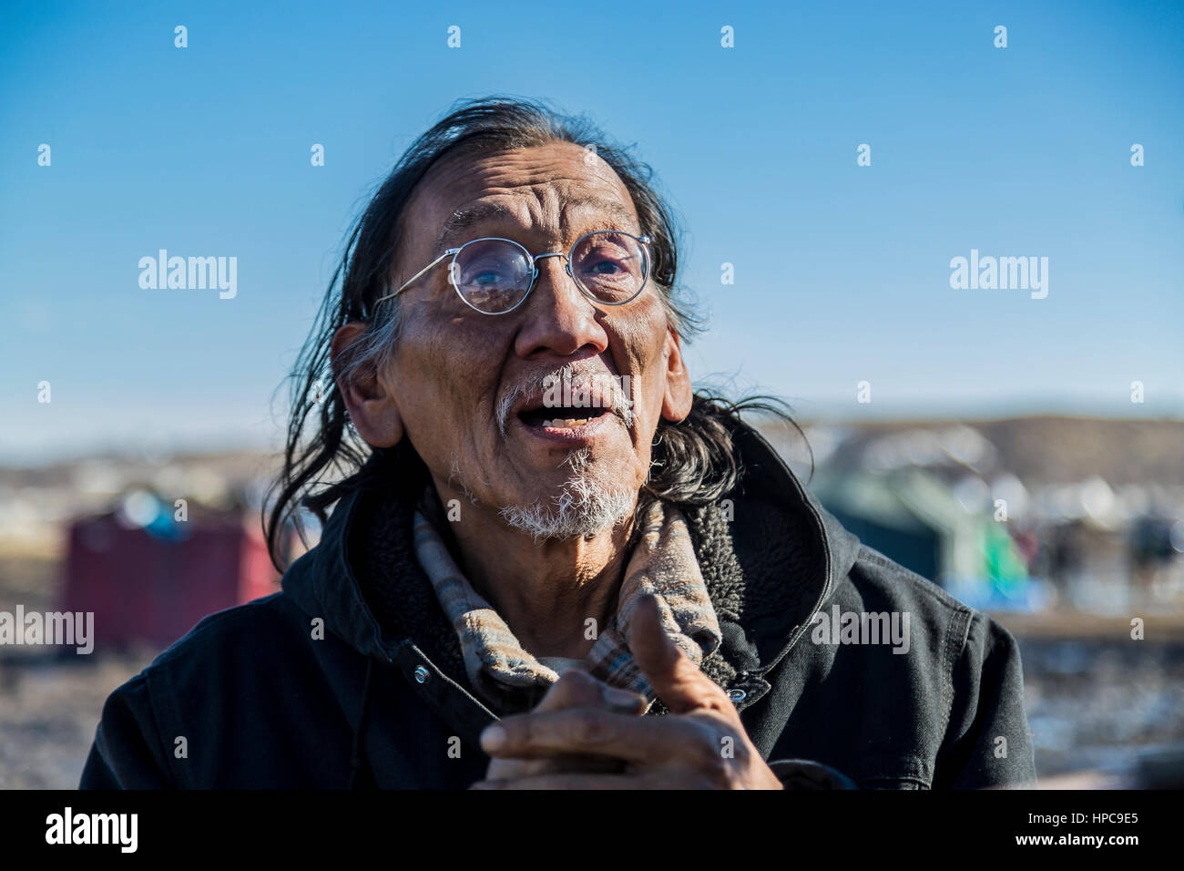 Nate Phillips of the Omaha Tribe, along with his 17-year-old daughter are two of the dozens of water protectors who say they will remain at the camp, citing that the pipeline is is being build on treaty land.  Hundreds of militarized law enforcement from various agencies, including The US National Guard and Homeland Security, will reportedly raid the camp at 2 p.m. on Wednesday, February 22, 2017 and will arrest all water protectors who refuse to leave.   Photo: Cronos/Michael Nigro Stock Photo