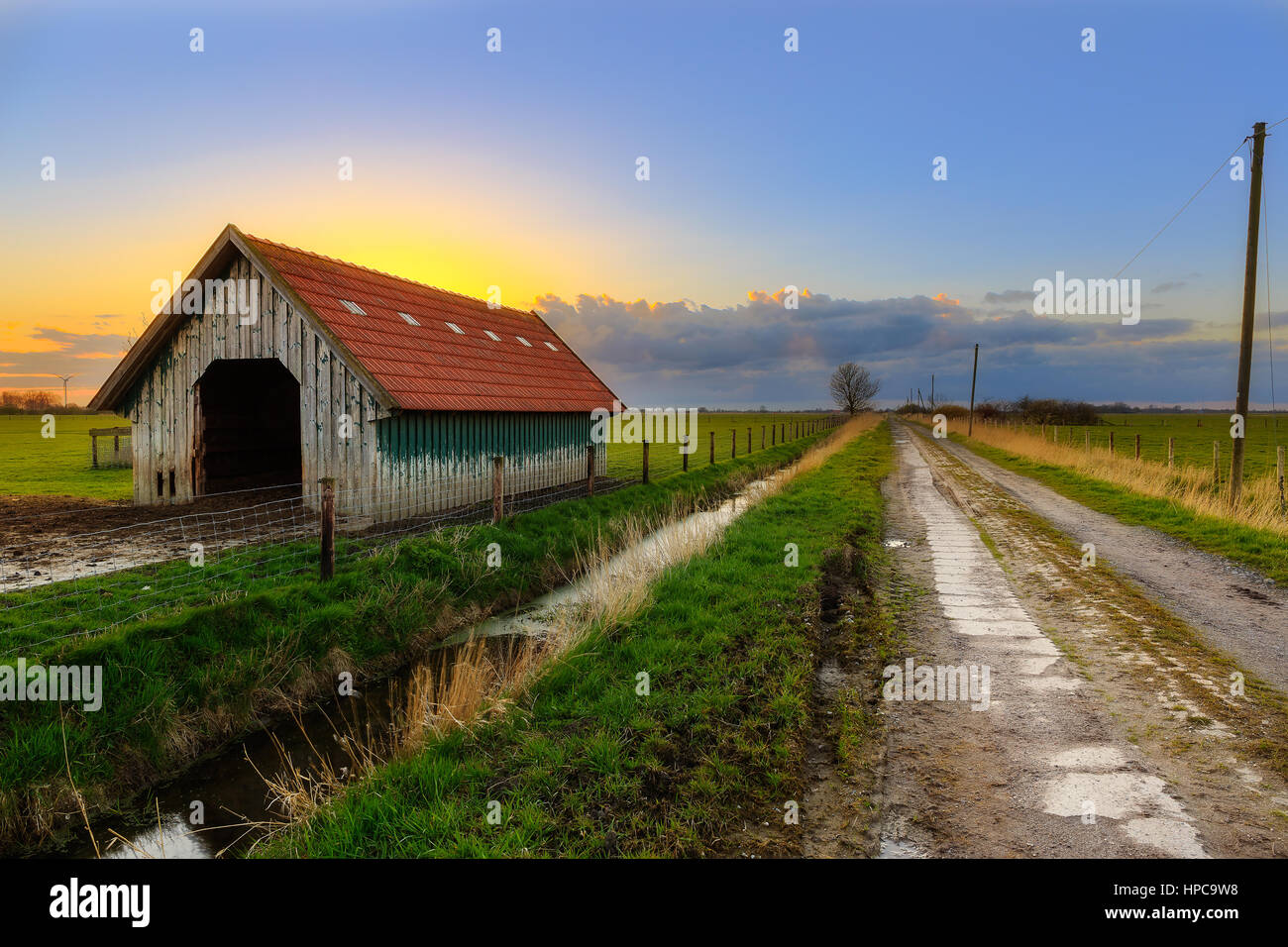 A barn in East Frisia at Sunset Stock Photo
