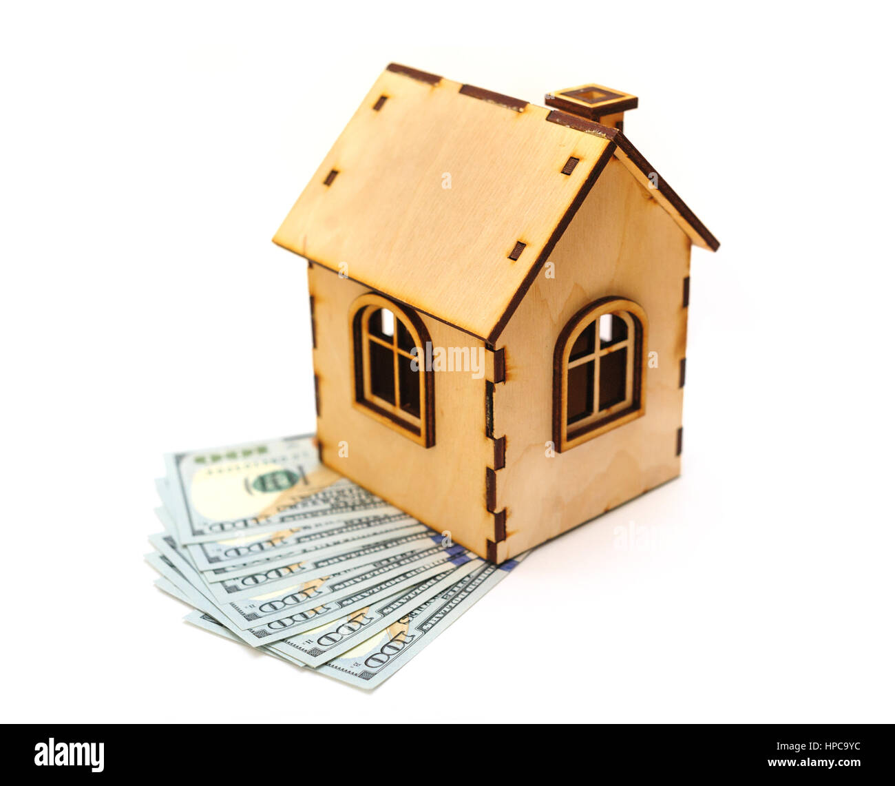hundred-dollar bills and wooden toy house Stock Photo