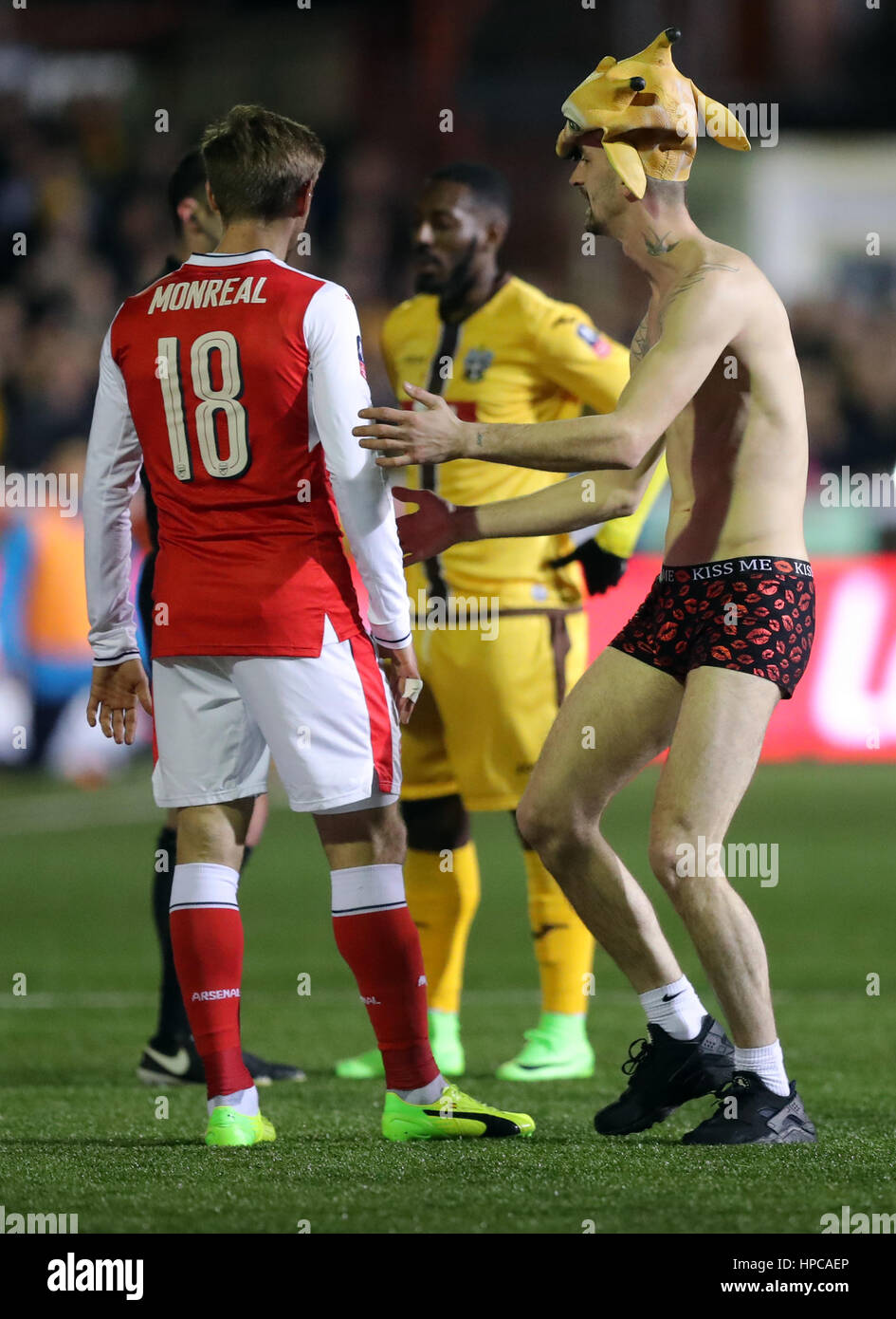 A fan invades the pitch towards Arsenal's Nacho Monreal during the Emirates  FA Cup, Fifth Round match at Gander Green Lane, London Stock Photo - Alamy