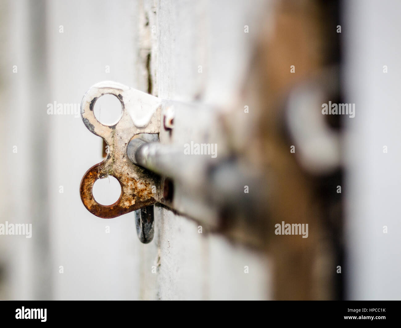 Rusty, damaged door latch, on a shed door Stock Photo