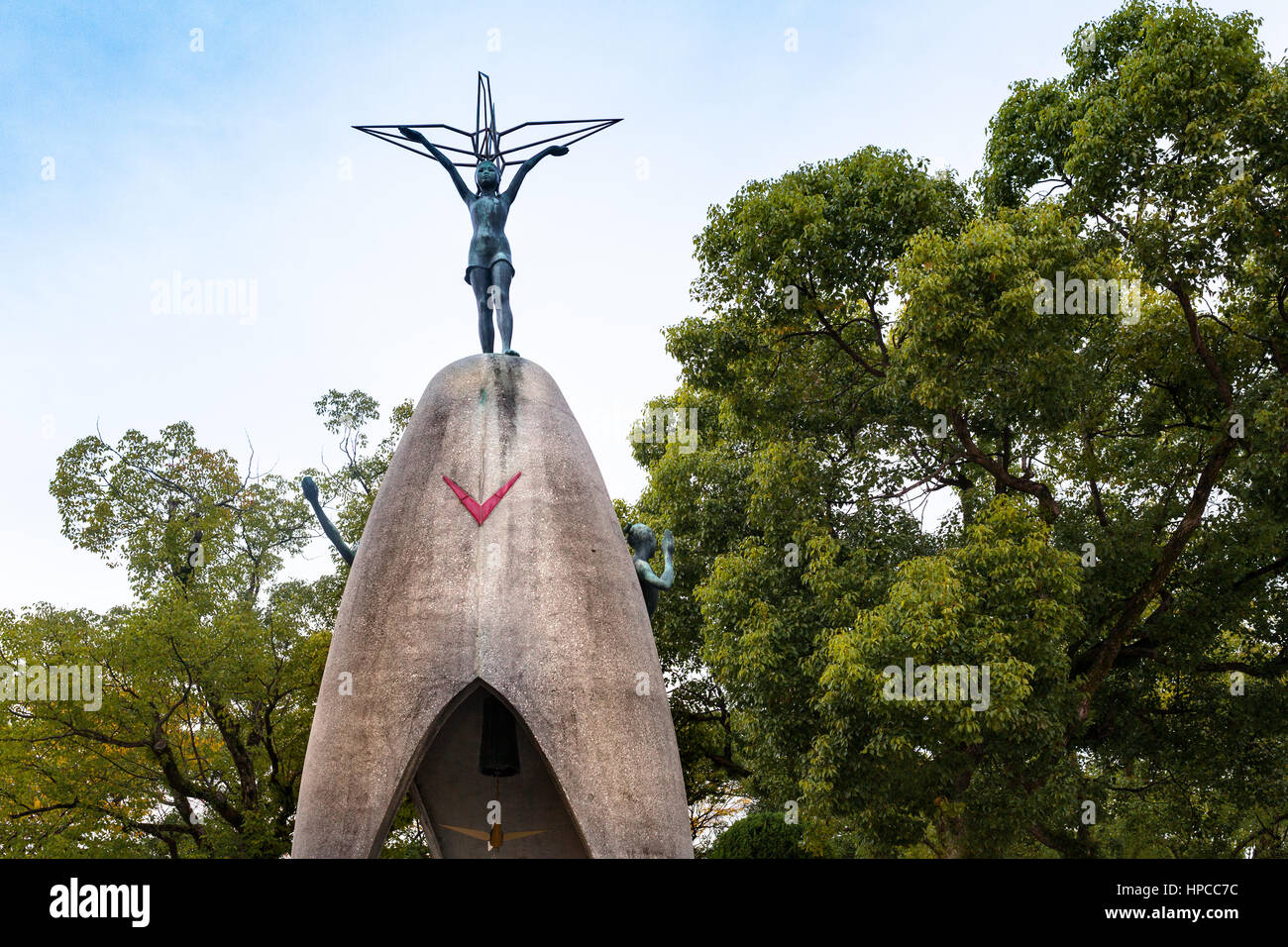 HIROSHIMA, JAPAN, NOVEMBER 21, 1015: The Children's Peace Monument, with a figure of Sadako Sasaki at the top of the statue, and a boy and a girl at t Stock Photo
