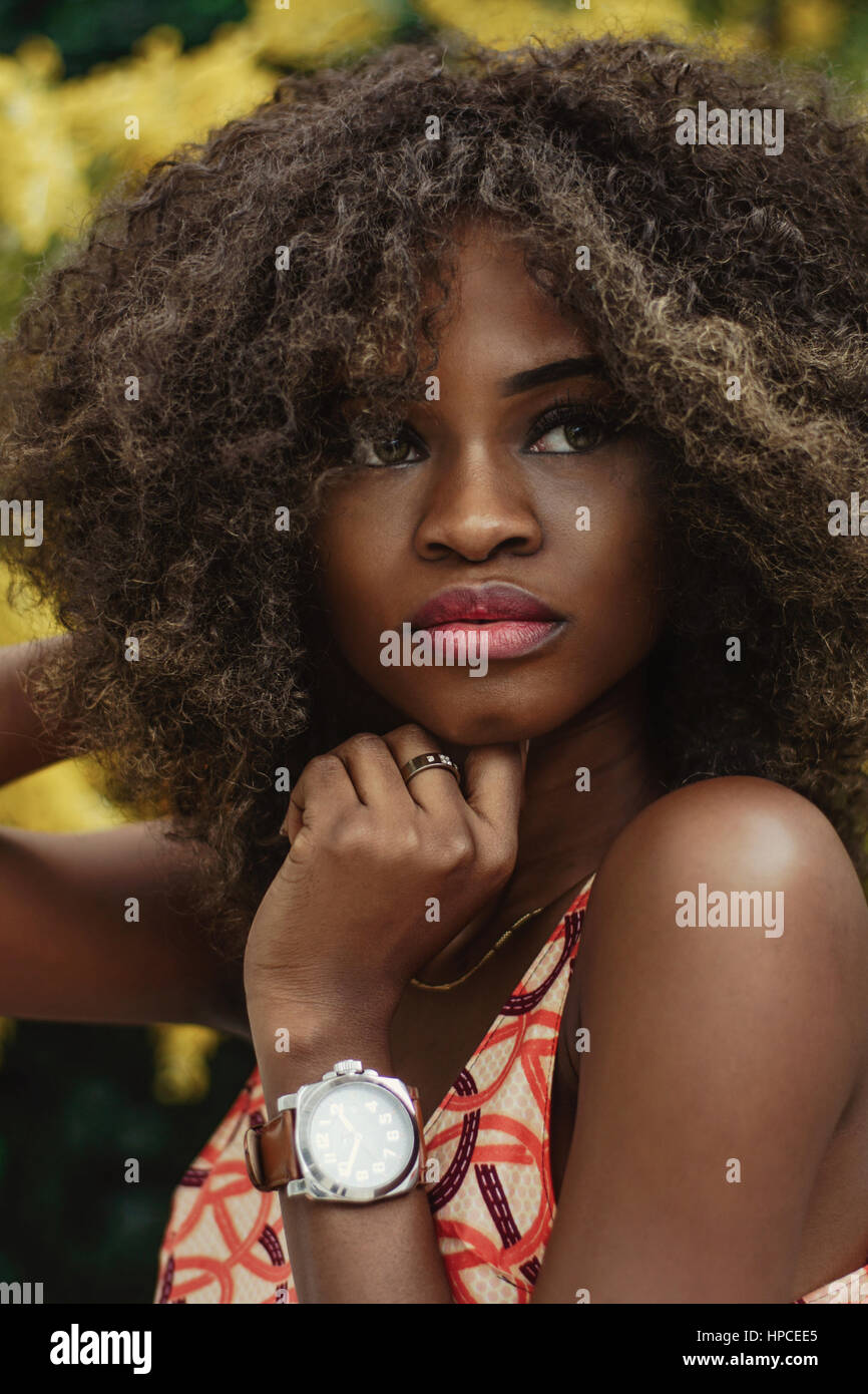 Portrait of beautiful afroamerican girl. Curly hair and pretty face ...