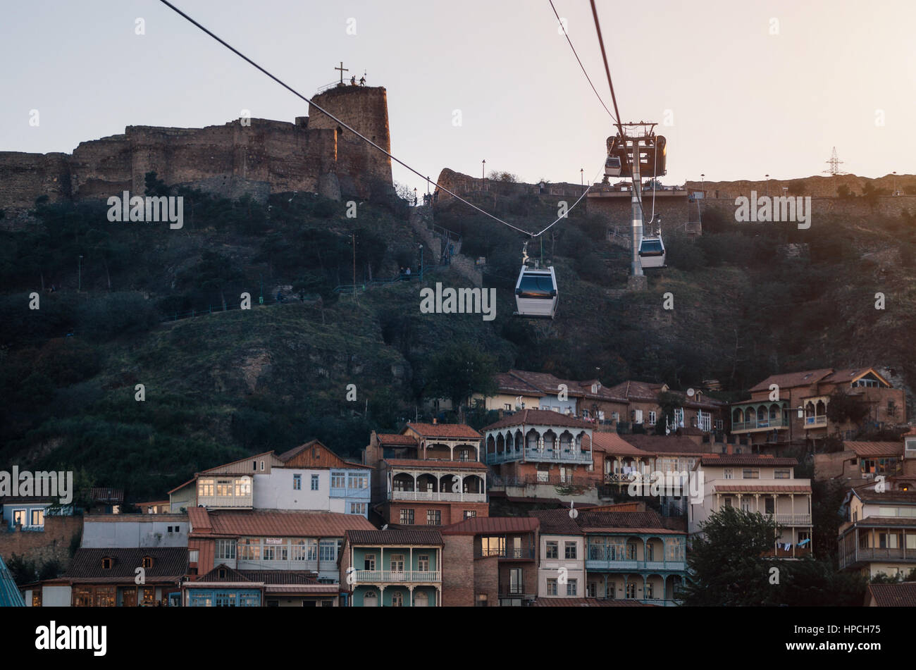 Tbilisi Old Town and Narikala Fortress on the background of the Cabs of the cableway at sunset. Landmark of Georgia Stock Photo