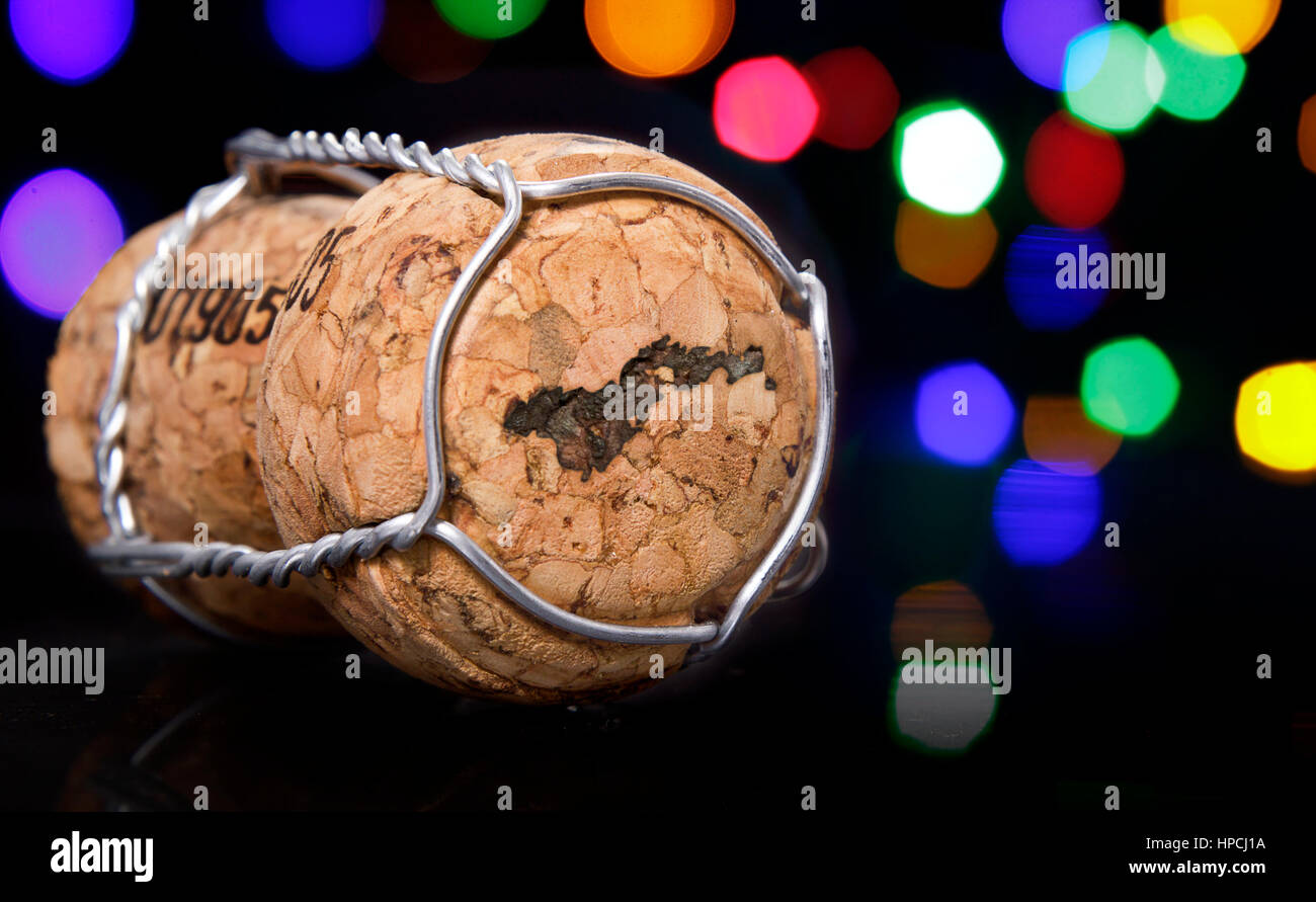 Champagne cork with the shape of American Samoa burnt in and colorful blurry lights in the background.(series) Stock Photo
