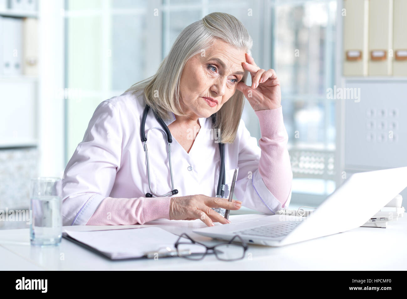 Tired mature female doctor hi-res stock photography and images - Alamy