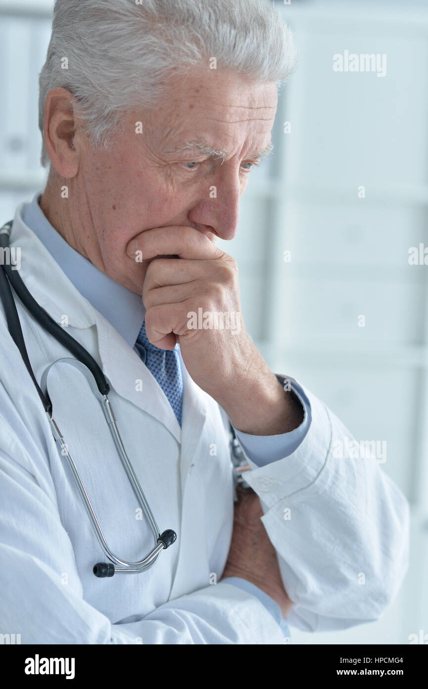 portrait of pensive senior male doctor with stethoscope Stock Photo - Alamy