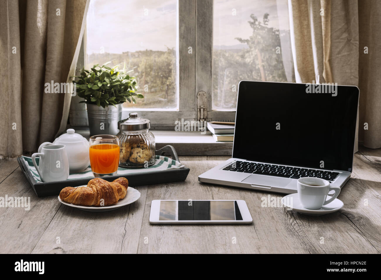 Laptop And Coffee On A Wooden Table In Front Of A Window In