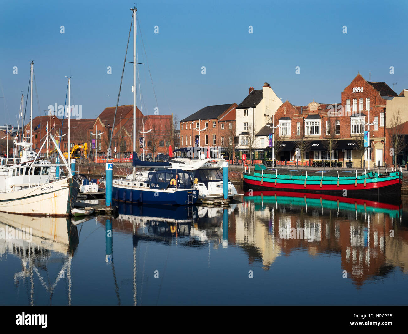 Boats and Buildings on Humber Dock Street reflected in Hull Marina Hull Yorkshire England Stock Photo