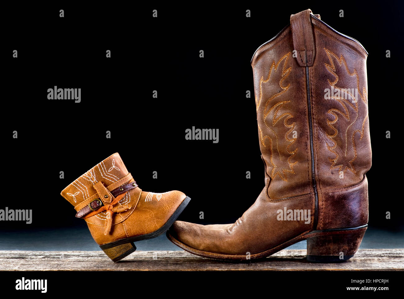 Baby cowboy boot and Dad cowboy boot with room for your type. Stock Photo