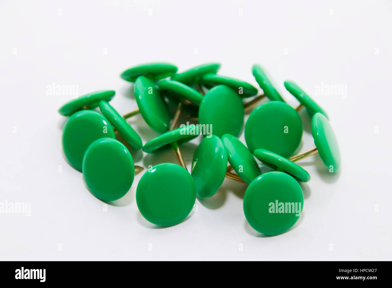 Green push pins on a white background Stock Photo
