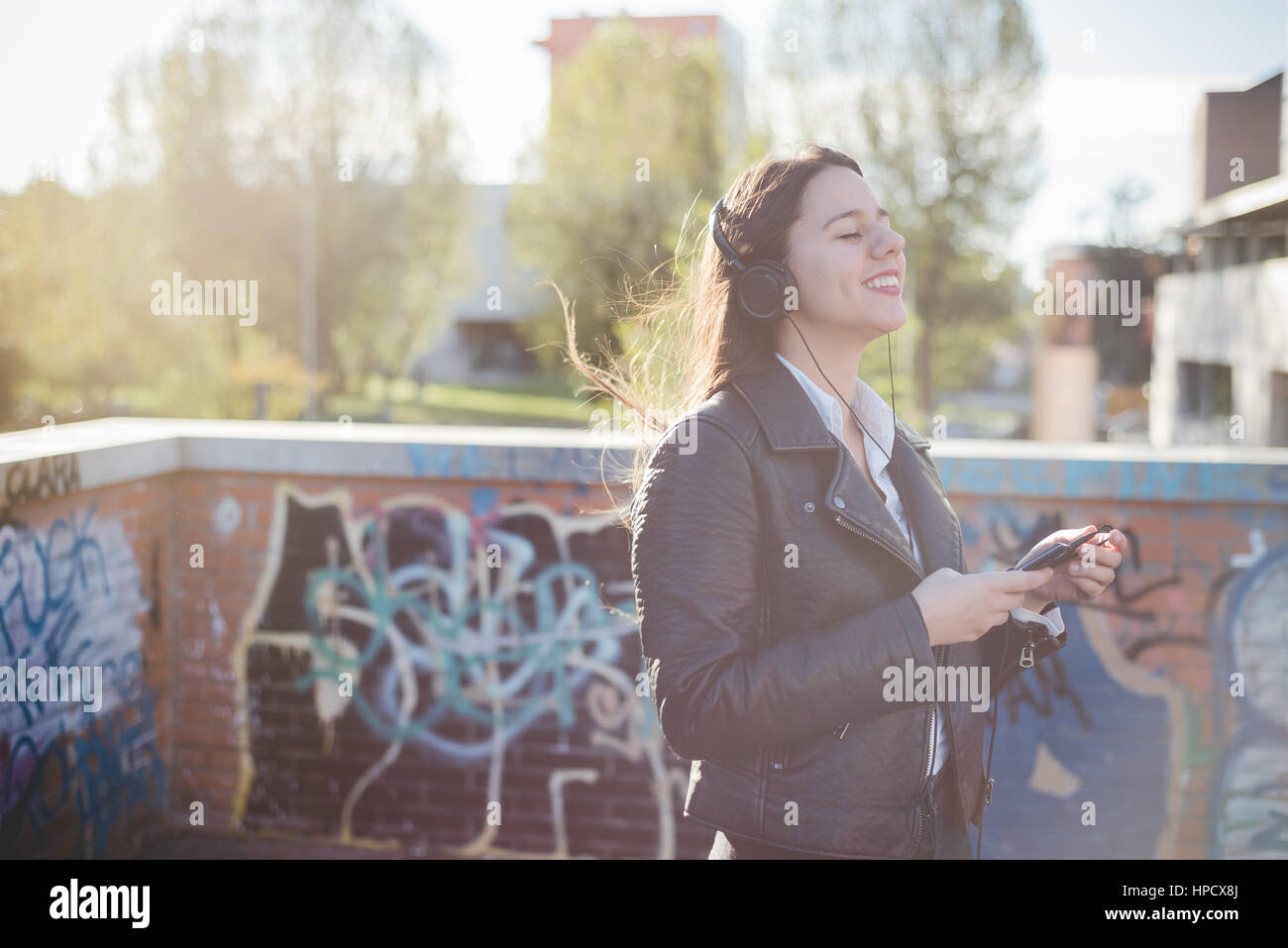 Young beautiful long hair caucasian woman listening music with ...