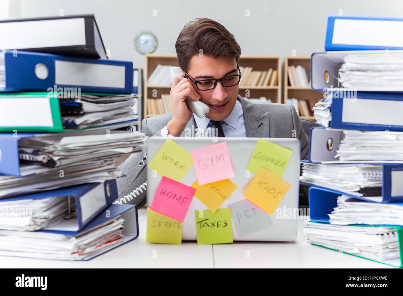 Multiple Priorities Image Businessman struggling with multiple priorities Stock Photo - Alamy