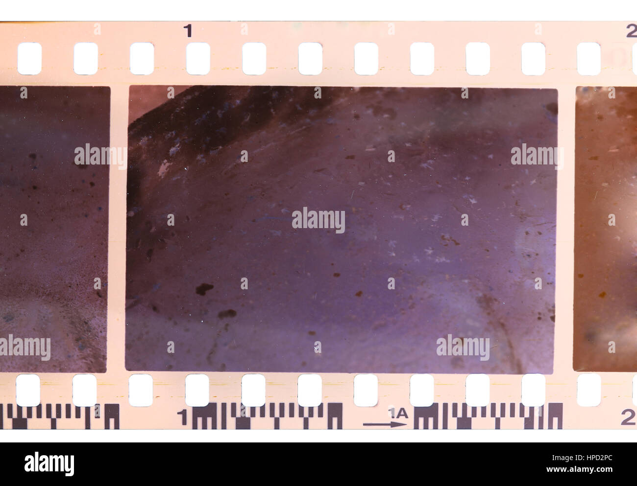 Strip of old, worn and bad developed color celluloid film isolated on white background Stock Photo