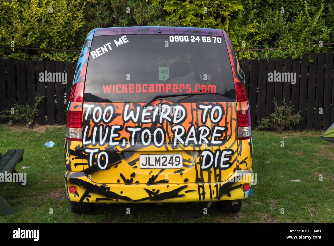 Cheekily sign written Wicked Campers camper van. New Zealand. Stock Photo