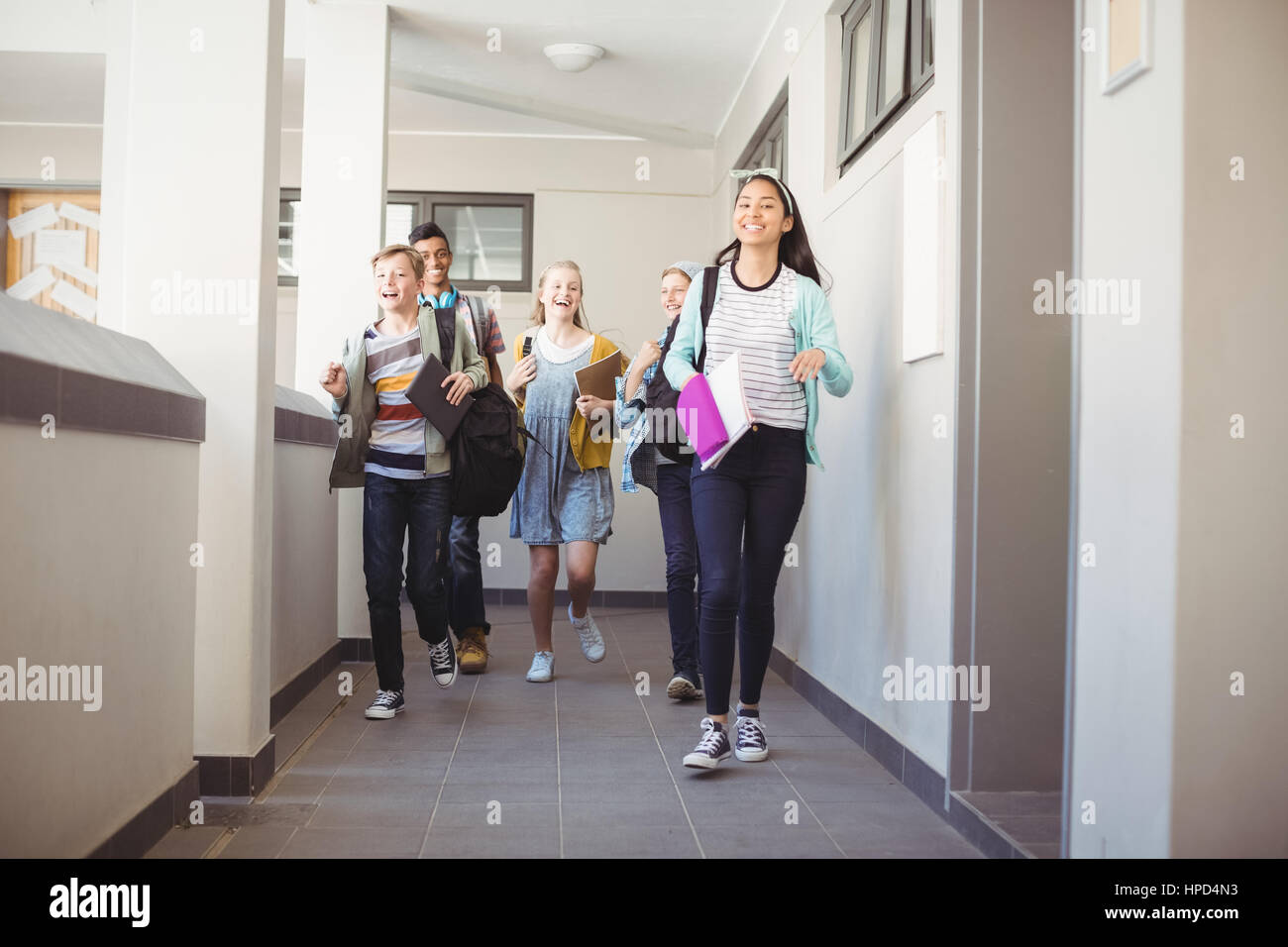Group of classmate running in corridor at school Stock Photo - Alamy