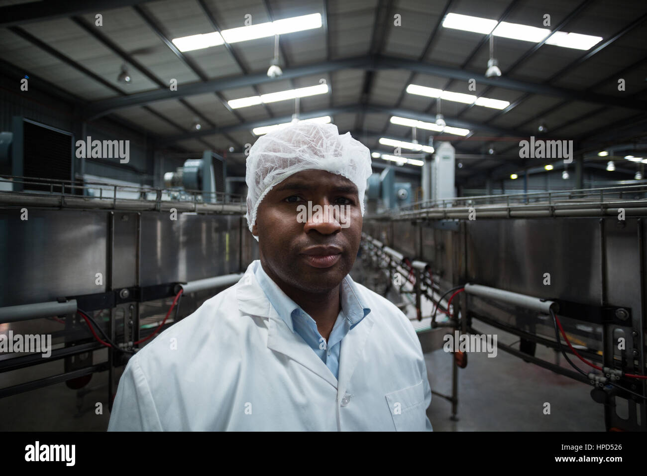 Portrait of factory engineer standing in bottle factory Stock Photo