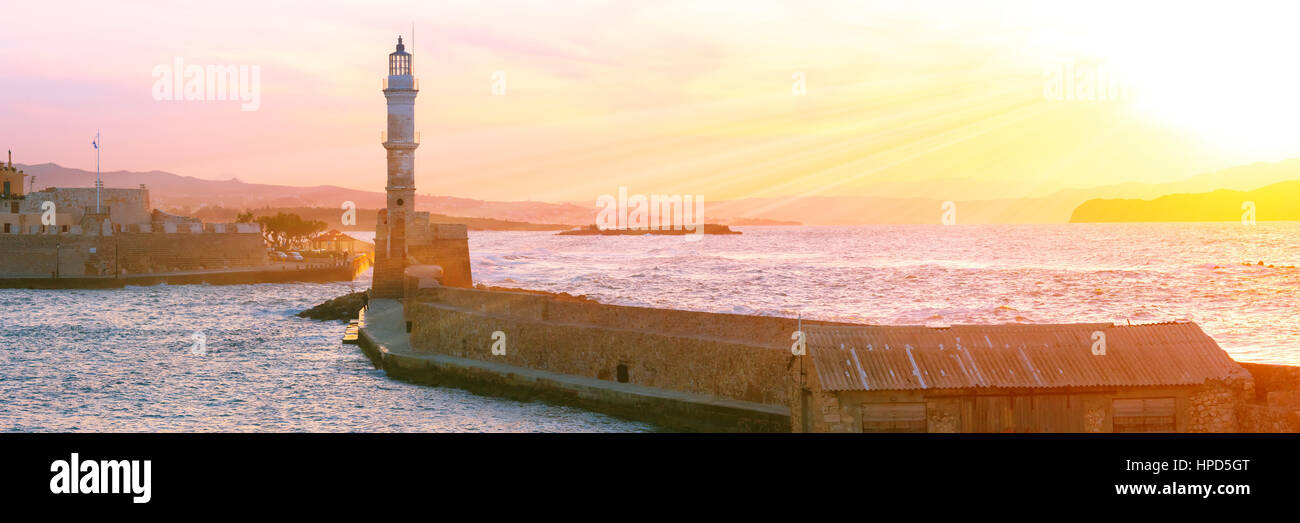 Lighthouse in old harbour of Chania at dawn, Crete, Greece Stock Photo