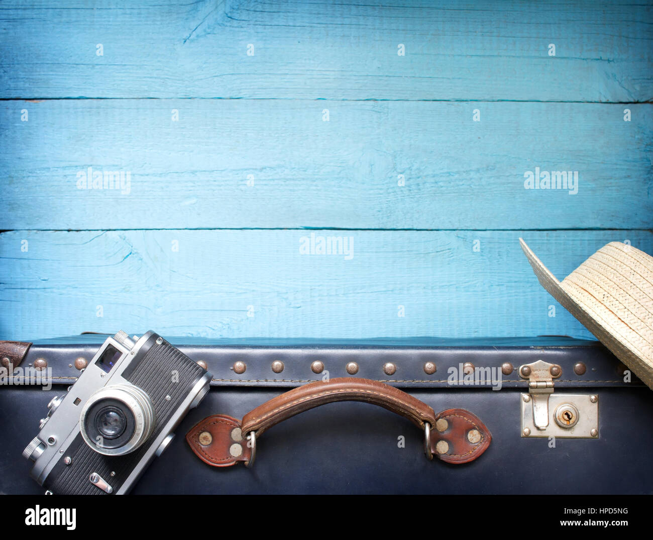 Old retro vintage suitcase and camera tourism travel background concept Stock Photo