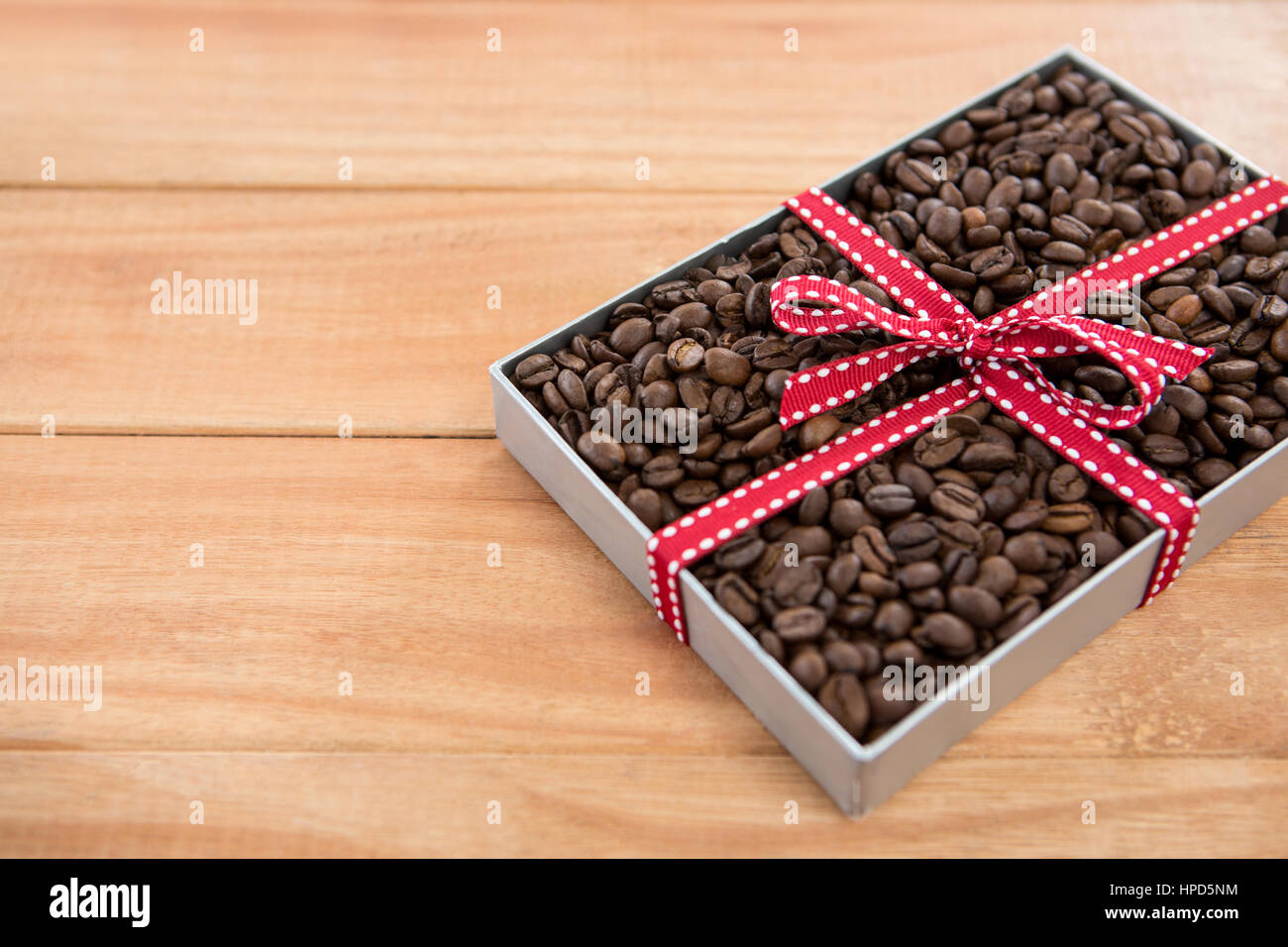 Roasted coffee beans in gift box on wooden background Stock Photo. a cup of