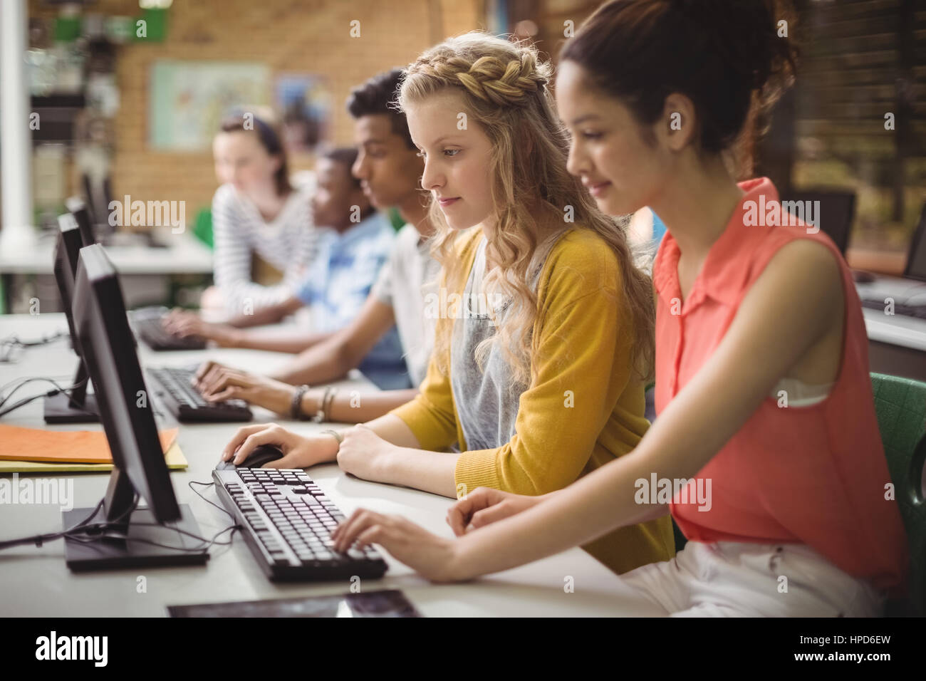 Smiling students studying in computer classroom at school Stock Photo ...