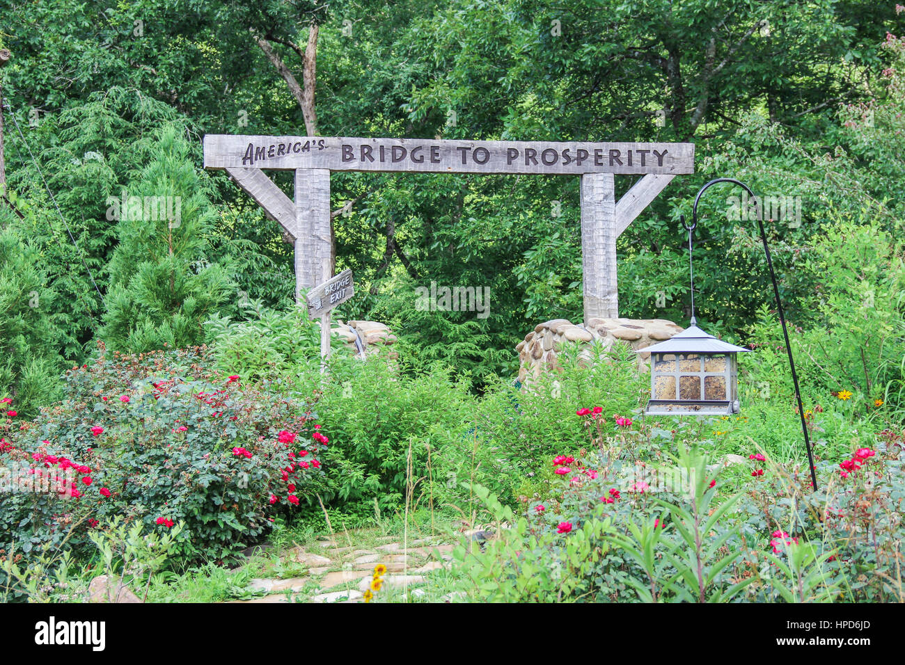 garden and America's Bridge to Prosperity suspension bridge at Foxfire Mountain Adventure Stock Photo