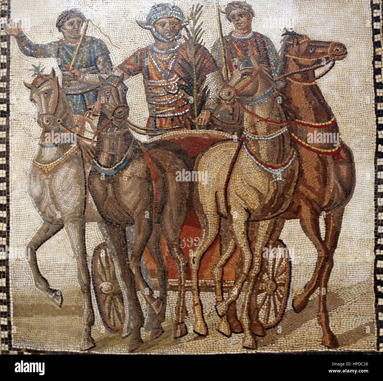 Quadriga of the factio russata. Mosaic. Limestone. 3rd century. Rome. The red team's driver, winner of the race, has taken the palm frond of victory.  Stock Photo