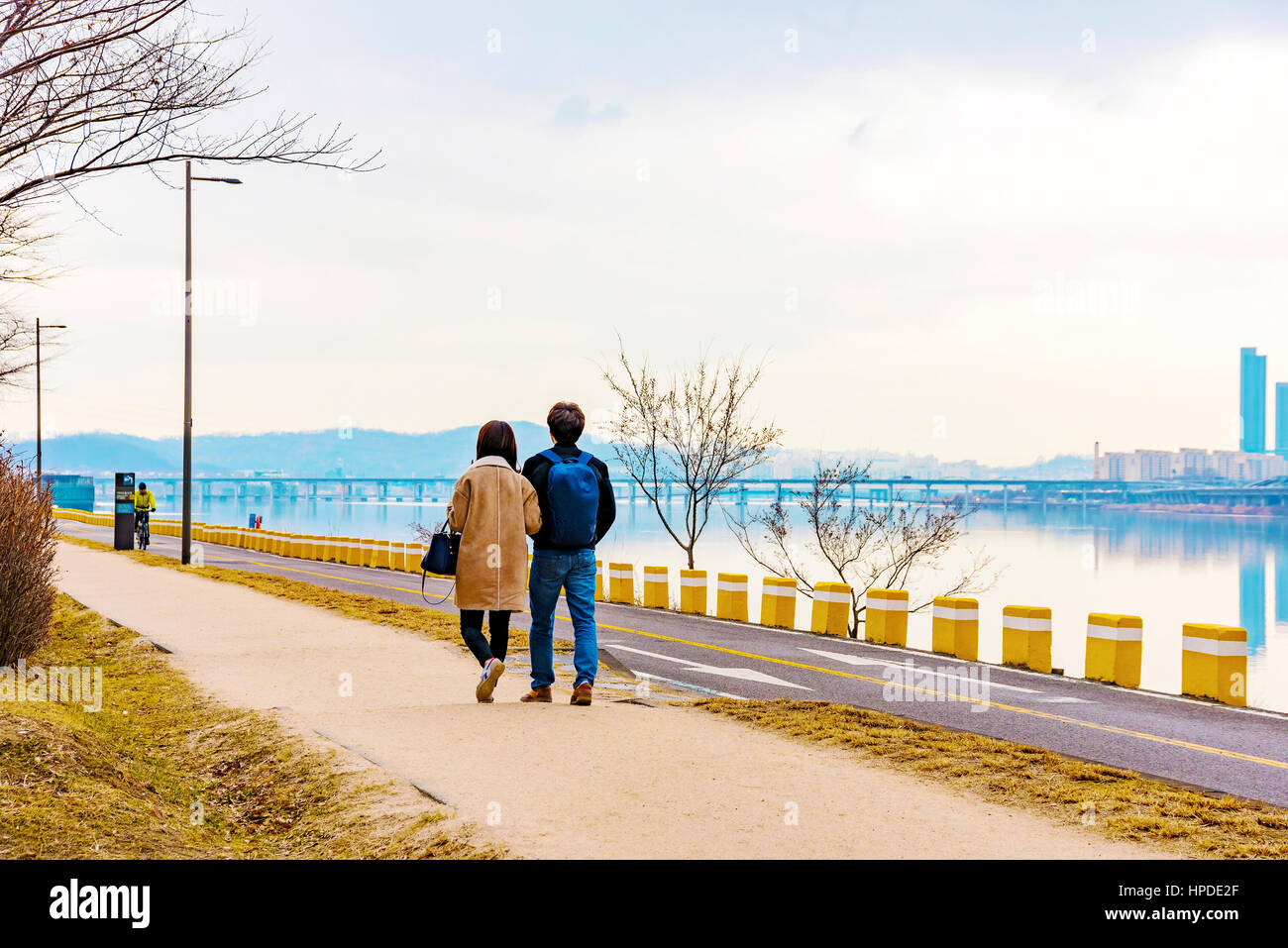 Romantic riverside landscape with couple walking Stock Photo - Alamy