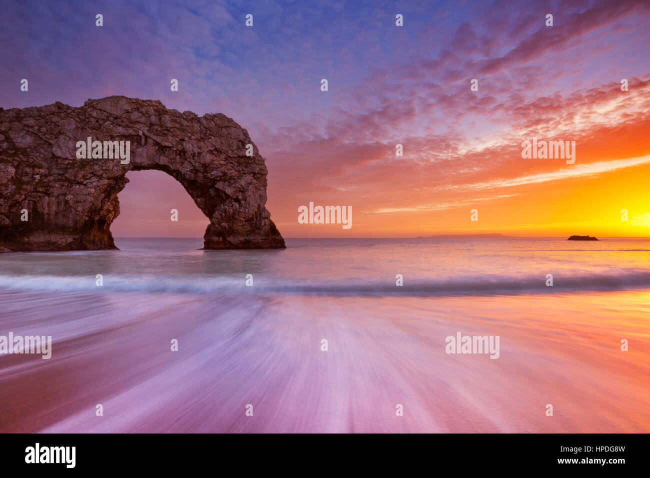 The Durdle Door rock arch on the Dorset Coast of Southern England at sunset. Stock Photo