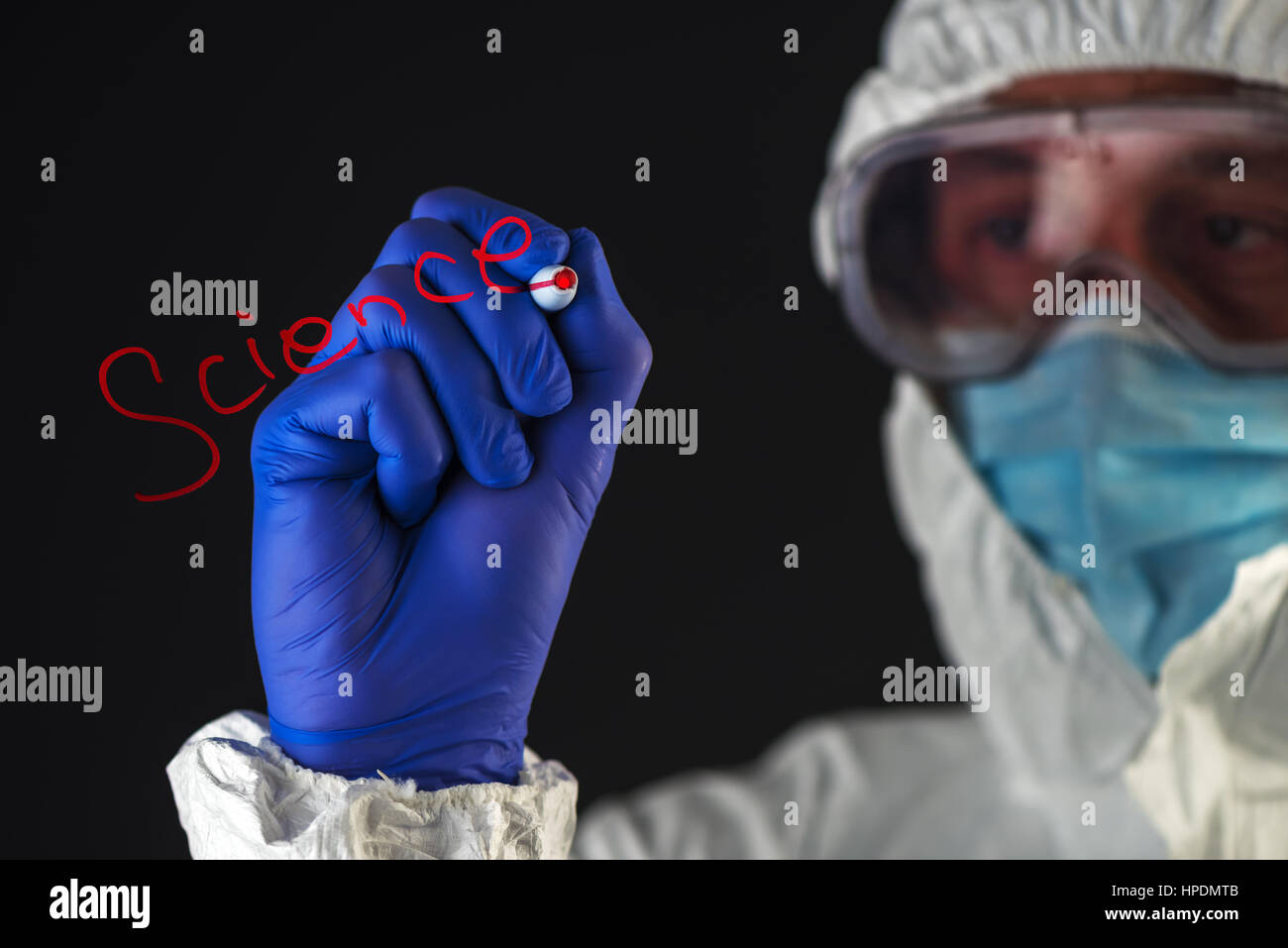 Scientist in protective clothes writing Science with red marker felt tip pen Stock Photo