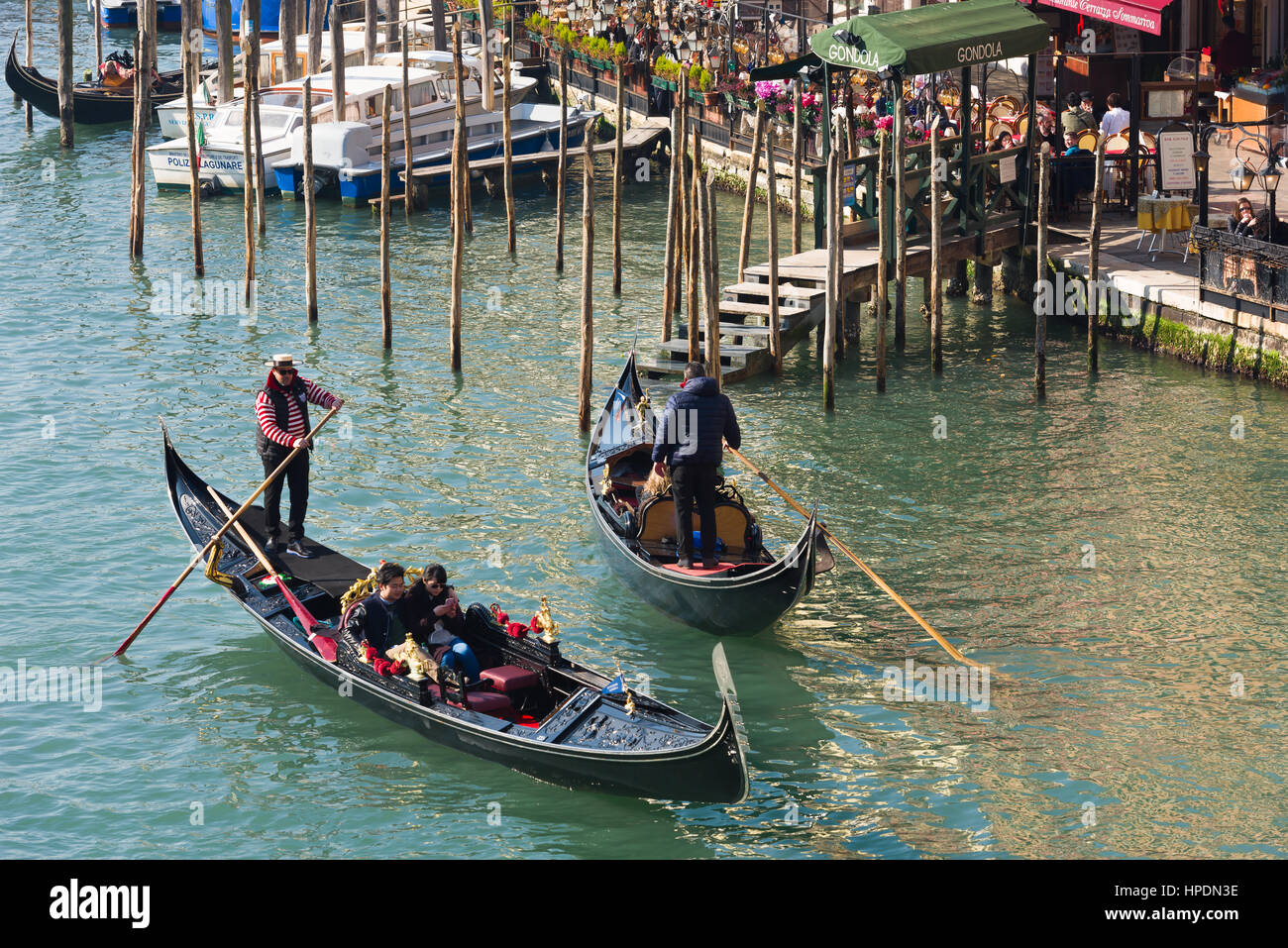 gondoliers are seen carrying passengers on the grand canal in venice Stock Photo