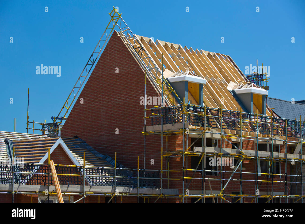 New Build Homes With Roof Construction Under Way Showing Dormer