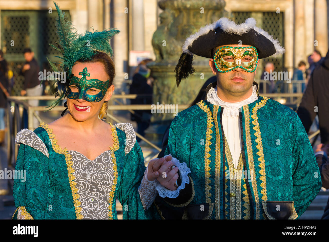 A man and a woman are seen walking through St Mark's square during the 2017 Venice Carnival Stock Photo