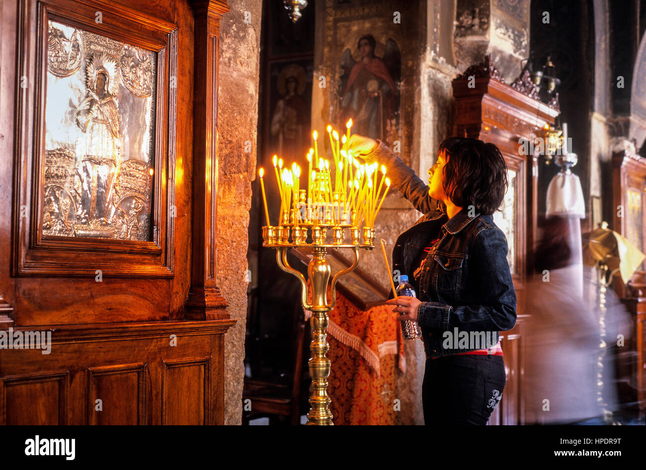 Kapnikarea church, byzantine style, woman doing an offering, Athens, Greece, Europe Stock Photo