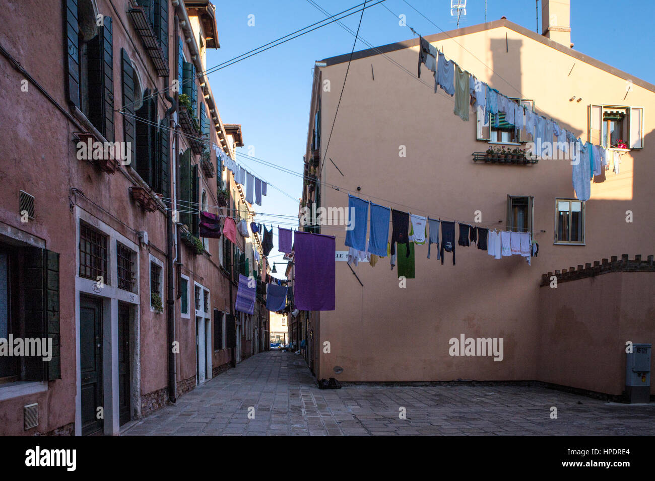 Laundry hanging to dry above a street in Venice Stock Photo