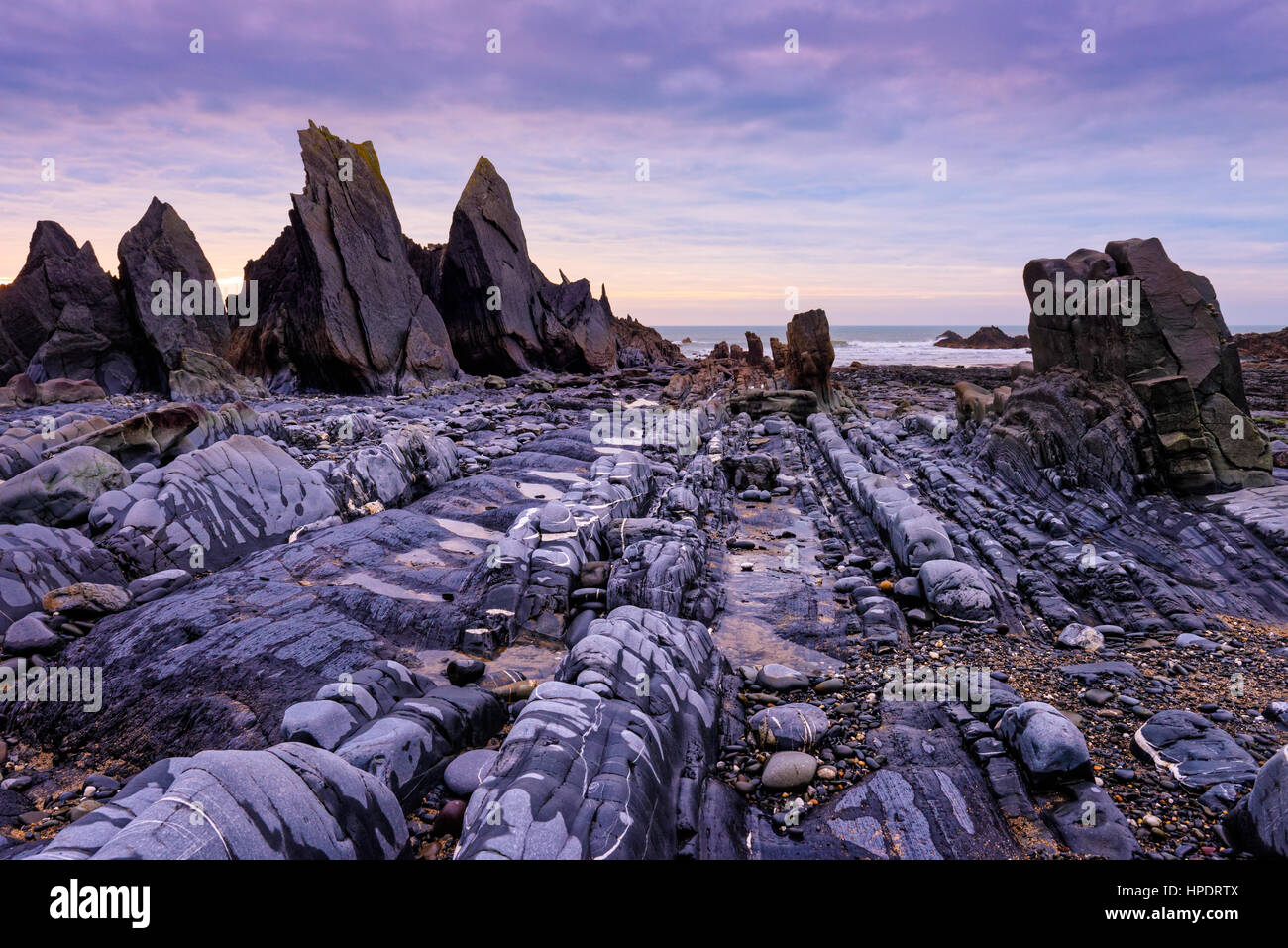 Rocks exposed at low tide at Duckpool on the Heritage Coast of North Cornwall, England. Stock Photo