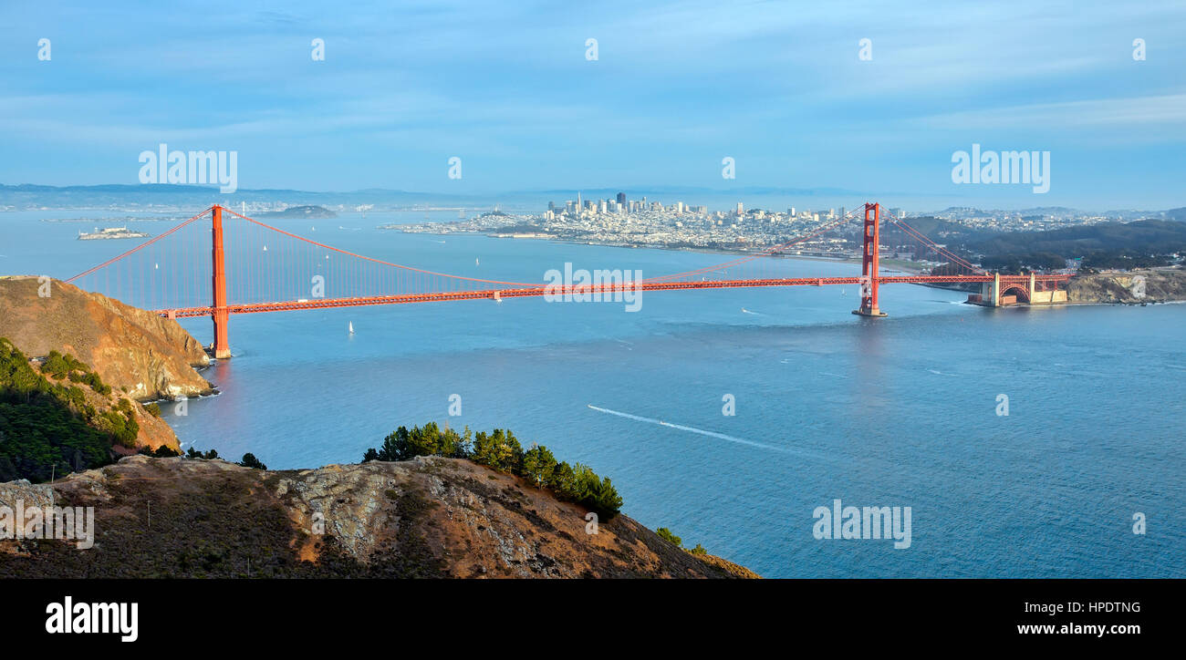 The Golden Gate Bridge with a panoramic view of the San Francisco skyline in the background, as seen from the top of Hawk Hill. Stock Photo
