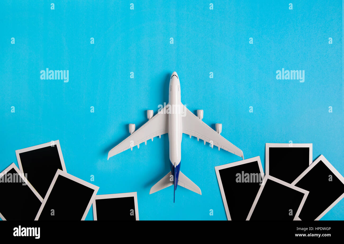 Preparation for Traveling concept, Airplane with Photo frame, on blue