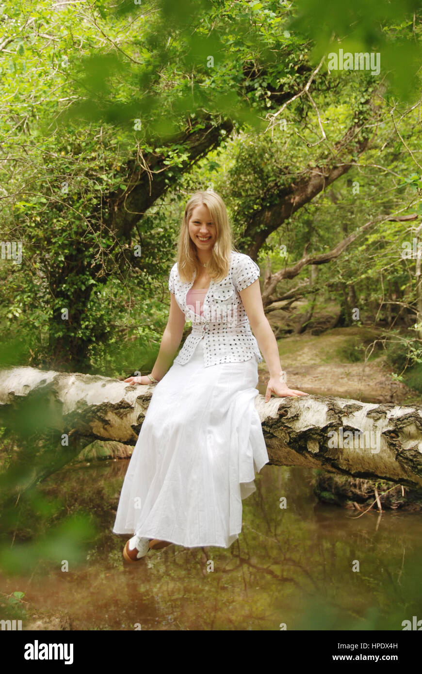 Pretty young woman in a long white dress in The New Forest Stock Photo ...