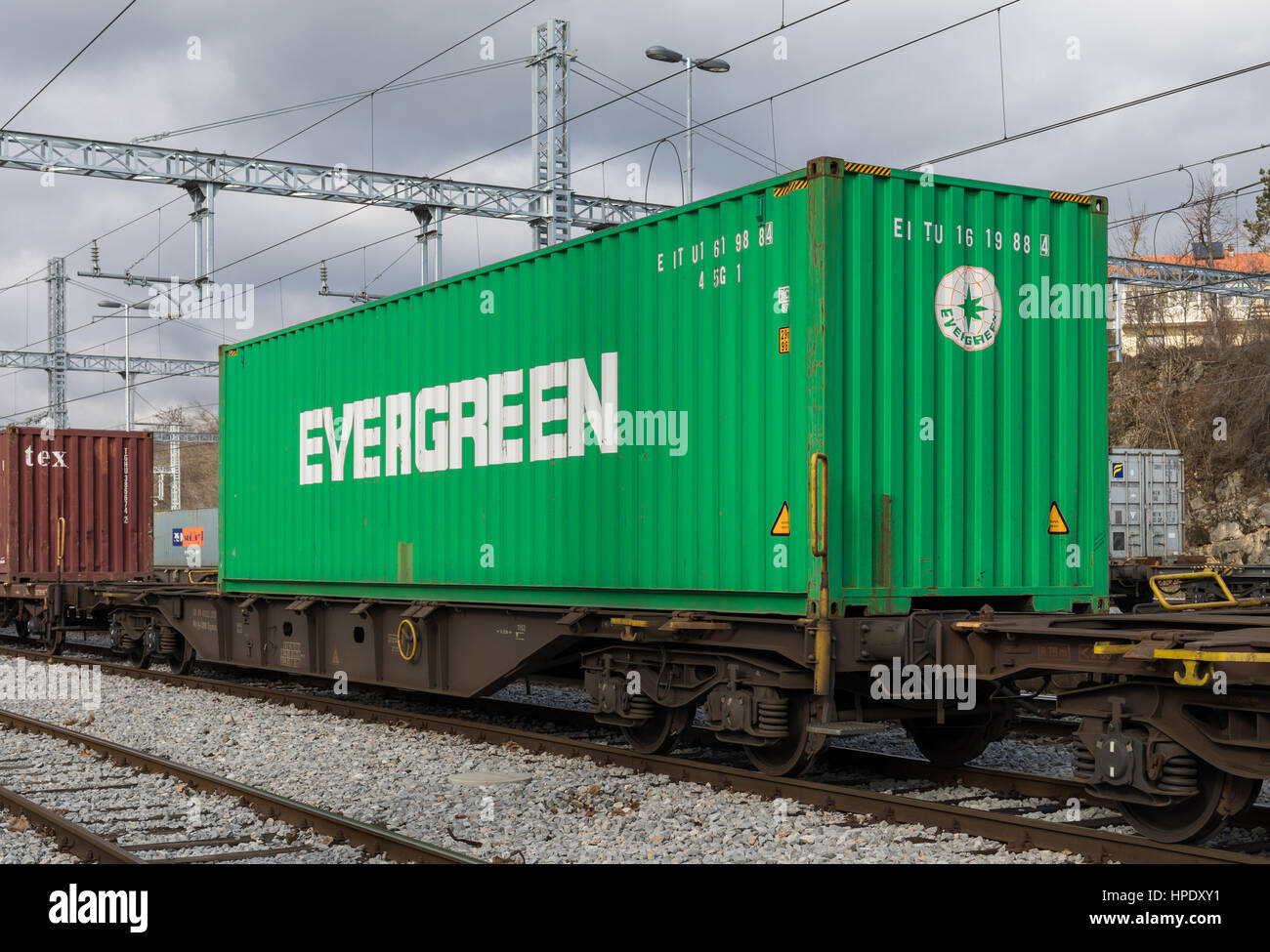 Freight train on railroad loaded with Evergreen cargo container Stock Photo