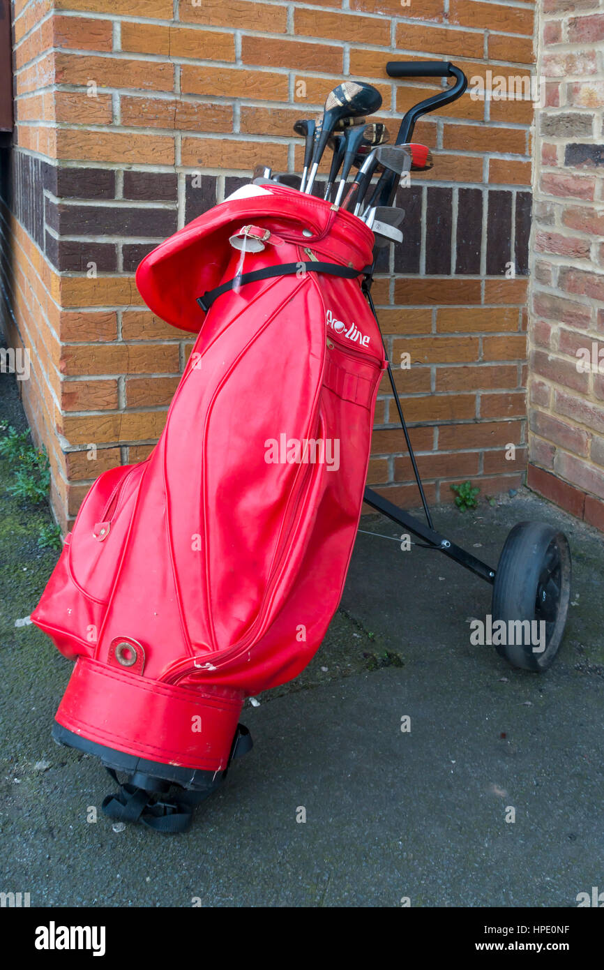 A set of second hand golf clubs in a red back donated to a Charity Shop for  sale Stock Photo - Alamy