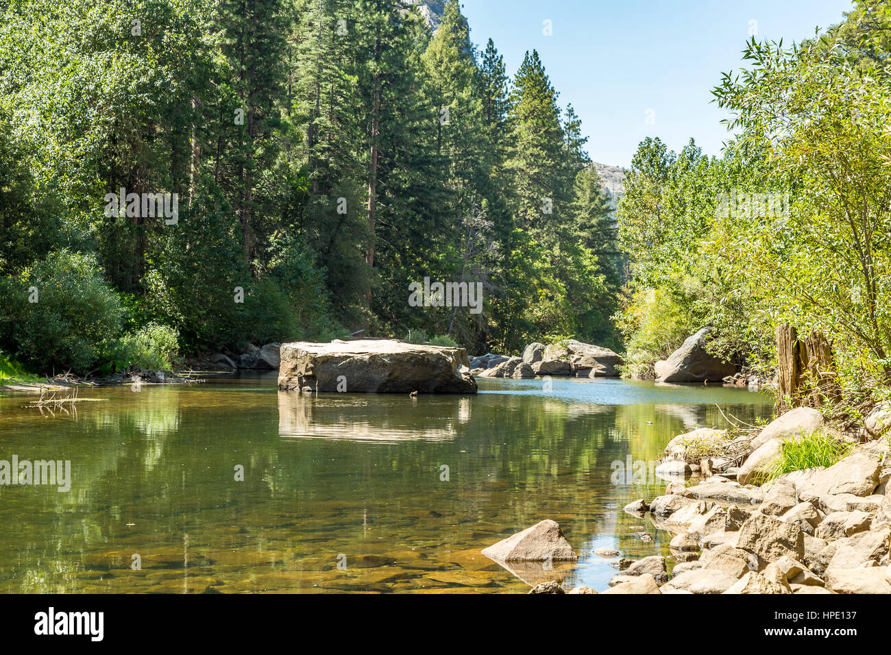 The Merced River in Yosemite Valley as it flows from the Sierra Nevada to the San Joaquin Valley. Stock Photo