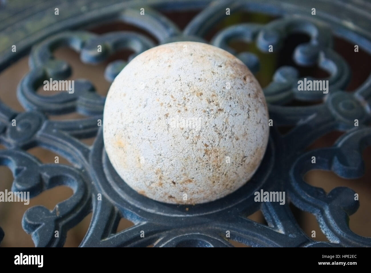 Old lacrosse ball sitting on patio table Stock Photo Alamy