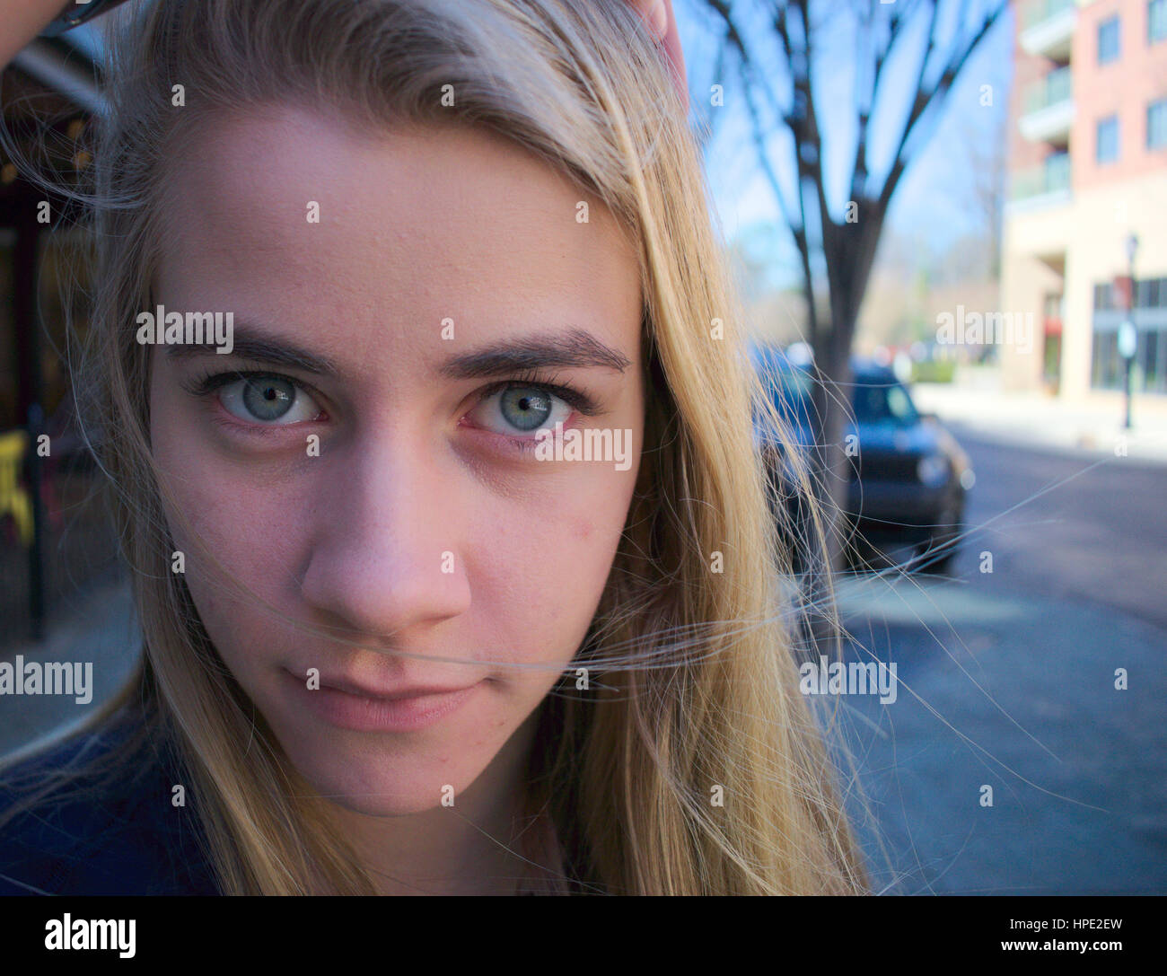 Blonde girl staring at camera Stock Photo