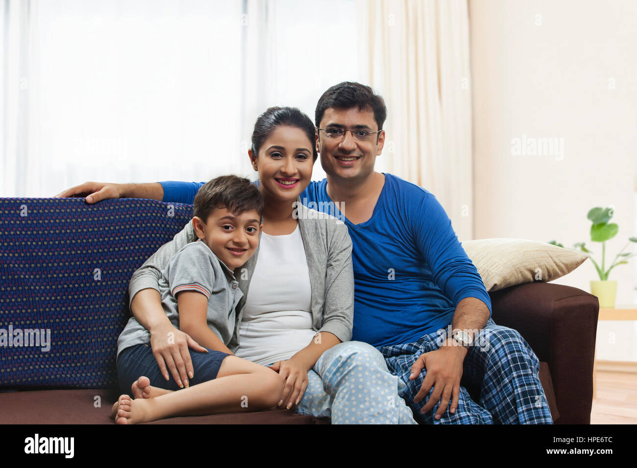 Portrait of parents and son sitting on sofa Stock Photo