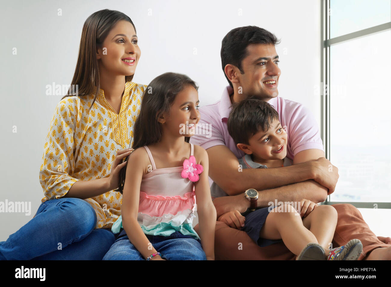 Family looking out of window Stock Photo