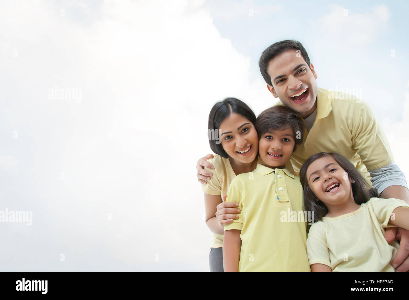 Happy young family against the clear sky Stock Photo